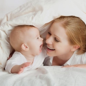 Baby with Mother smiling after New Parent online parenting class in Livonia, Michigan