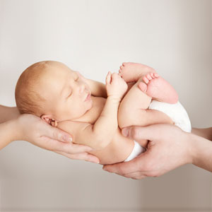 New parents holding baby