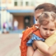 Child hugging mother goodbye at school. Experiencing feelings of separation.