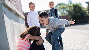 Children experiencing bullying. Girl has her head down while getting yelled at by bully.