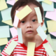 Child surrounded by sticky note labels