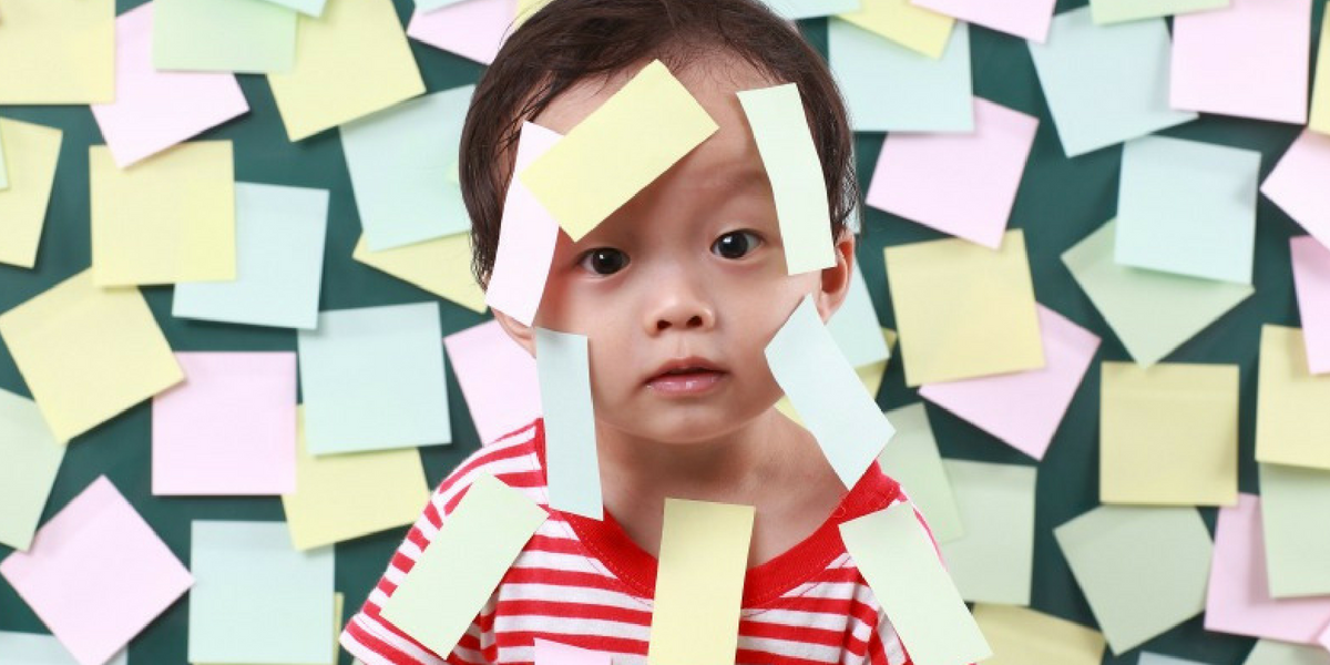 Child surrounded by sticky note labels